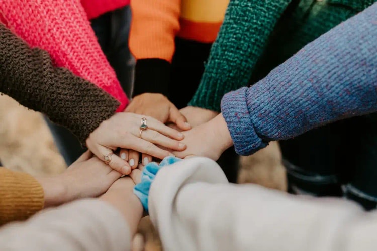Volunteers joining hands in support
